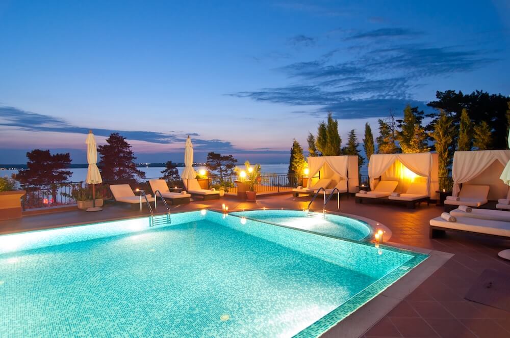 Luxury pool area with spa