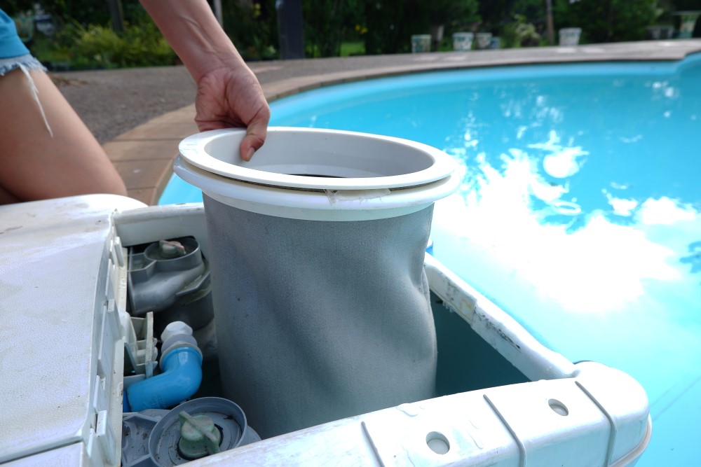 A person taking apart a pool pump to examine it's parts.