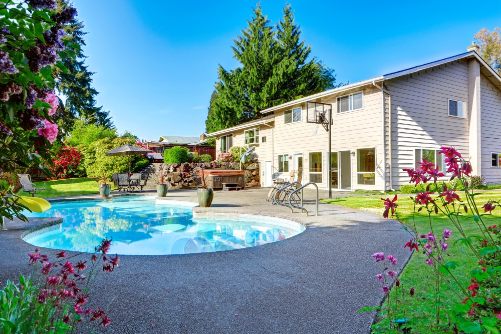 A house in an HOA community with a pool in the backyard.